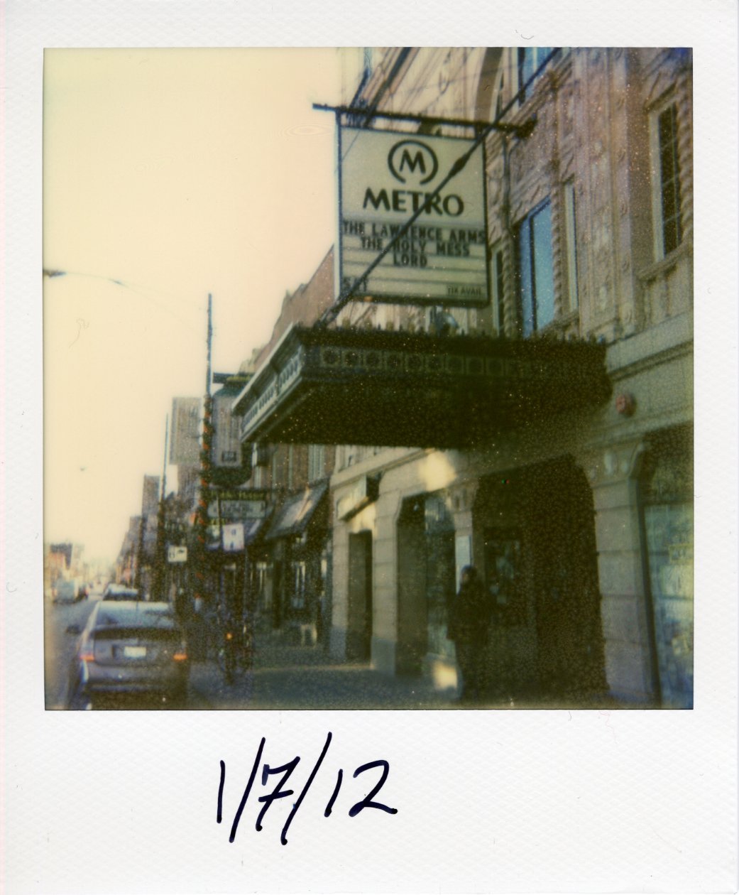 Looking south on Clark Street in Chicago at the marquee for The Metro advertising a lineup of bands: The Lawrence Arms, The Holy Mess, and Lord