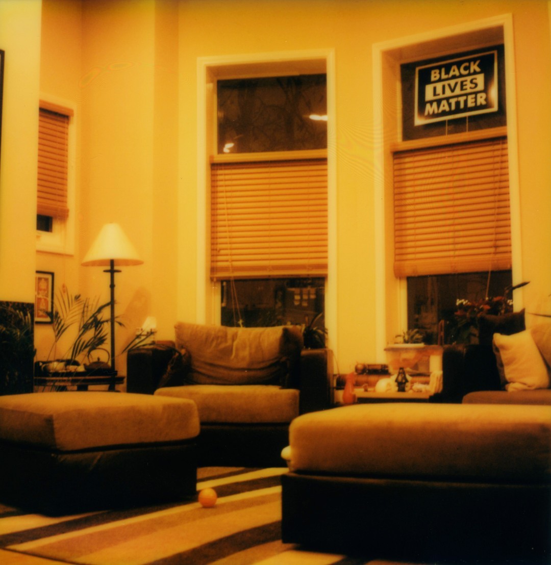 A contemporary living room with couches and ottomans.